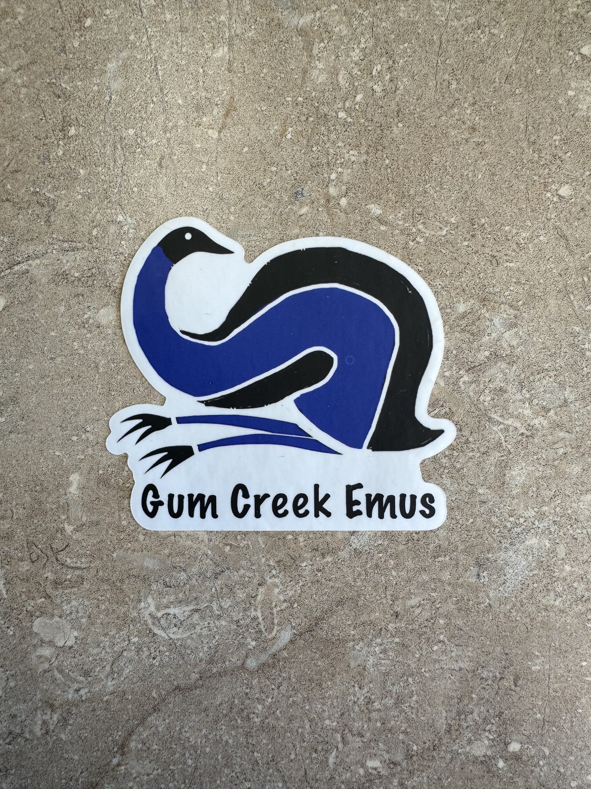 gc3 Emu sticker featuring a stylized blue and black design with the text "Gum Creek Emus" on a textured stone background.
